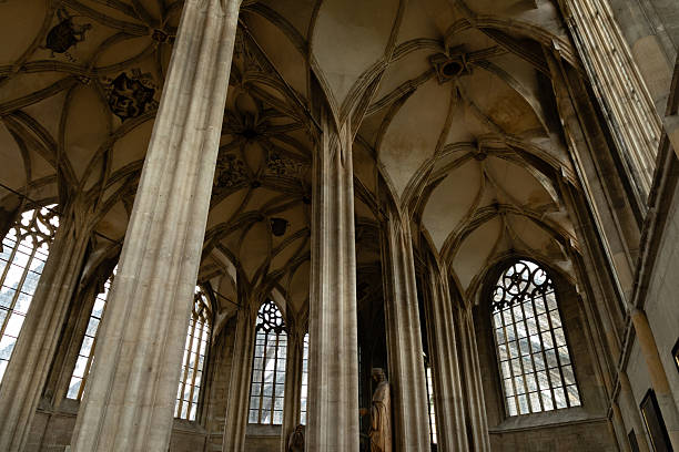 Kutná Hora, Czech Republic  August 8, 2025: Upper triforium gallery view revealing Gothic vaulted ceilings and exterior flying buttress support system visible through windows, Cathedral of Saint Barbara, Kutná Hora