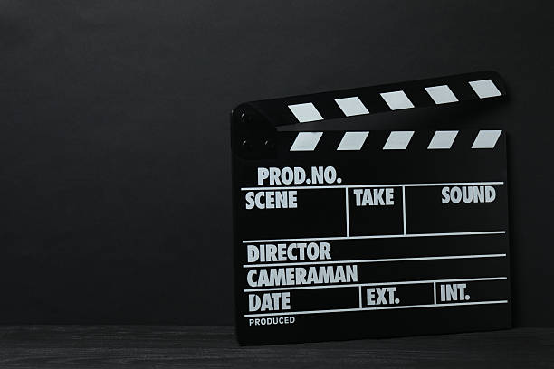 istock Movie clapper and reel on black background, popcorn 3D glasses 2256780156
