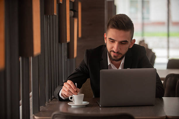 istock Young business man working on a laptop at office or cafe restaurant. 2256782129