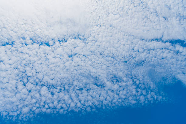blue sky with a clouds. Clear blue sky panoramic background with small white clouds. Partly cloudy. White fluffy clouds in the blue sky
