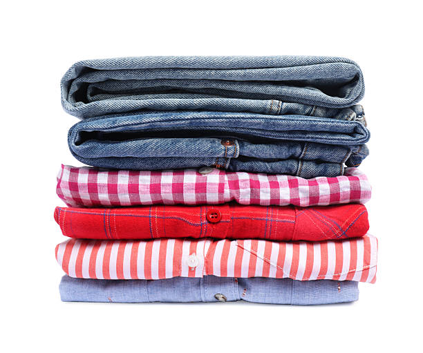 Multicolored casual clothes folded in pile on white background