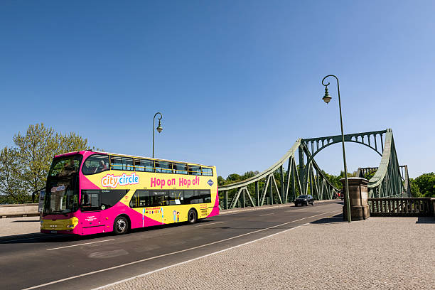 A tour bus drives over the Glienicke Bridge (or Glienicker Brücke in German) in Potsdam, Germany, on May 8, 2022.  During the Cold War, it served several times as the site where captured Warsaw Pact agents would be exchanged for Western spies. It was feature in. Steven Spielberg's film Bridge of Spies.