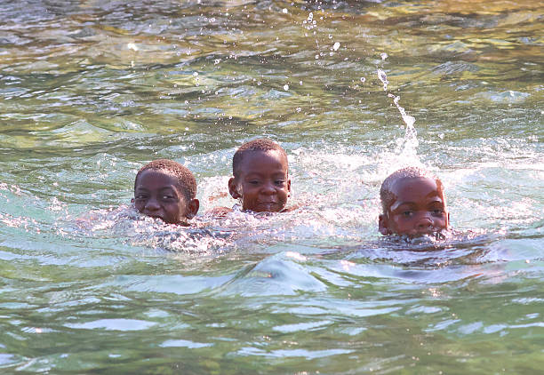Beautiful girls enjoying sea on a sunny day. They are happy, smiling, playing and laughing.