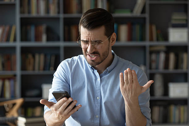 istock Nervous angry young businessman reading rejection notice on smartphone screen 2256797151