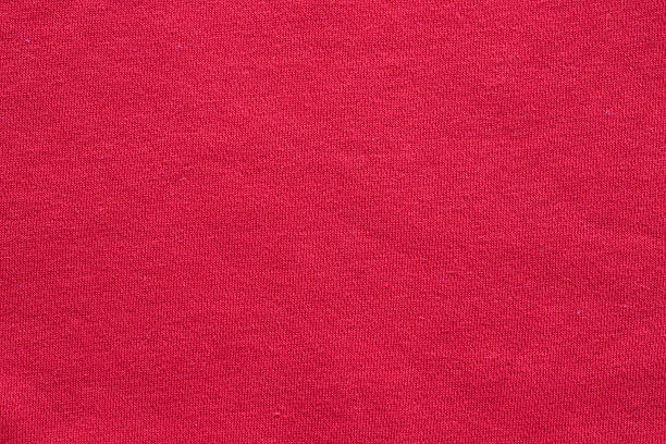 Bright red cotton fabric texture with fine jersey weave pattern for vibrant fashion apparel and textile background design