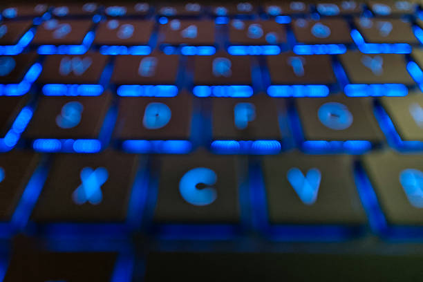Young Latina woman from Bogota Colombia between 20 and 24 years old, plays her video games from her computer while she is locked in her room with the lights off