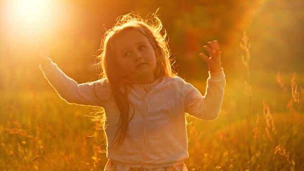little girl playing in the park on a sunny spring day