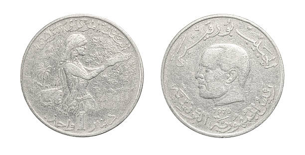 Vintage Tunisian 1 dinar coin from 1976 featuring agricultural worker sowing seeds on one side and a portrait with Arabic inscriptions on the other, isolated on white.