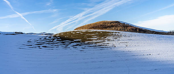 Snowy slopes and distant continuous mountain ranges