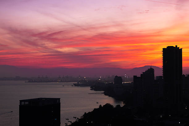Sun is rising on George Town, Penang Island.Buiding silhouettes at sunrise.