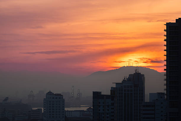 Sun is rising on George Town, Penang Island.Buiding silhouettes at sunrise.
