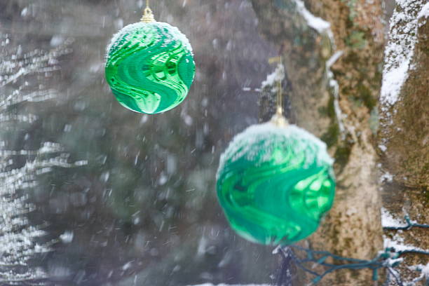 Large Christmas Ornament Outside with Snow Falling