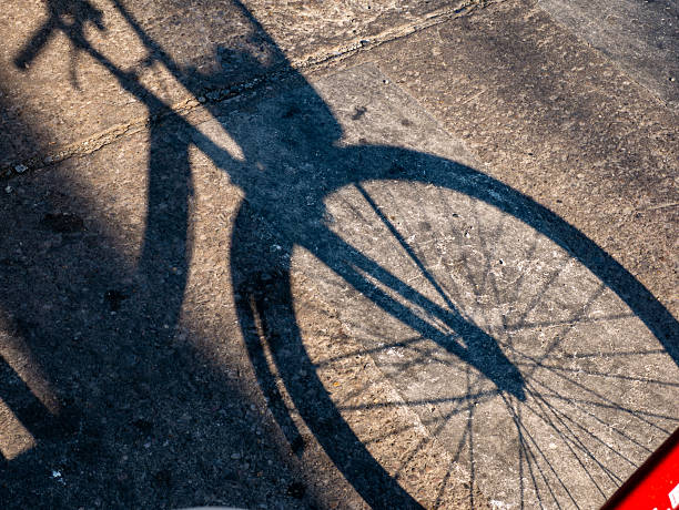 Bicycle Shadow Cast on Concrete Ground in Afternoon