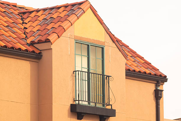Building with double pane patio doors and brown adobe or stucco.