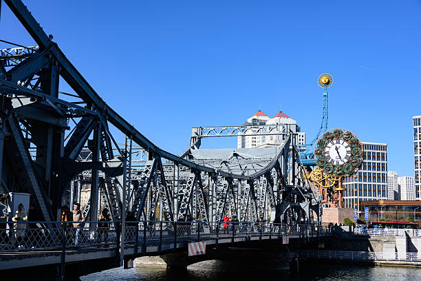 The historic Jiefang Bridge in Tianjin is captured alongside its neighboring iconic clock tower, with the calm Haihe River below reflecting the city's fusion of European architecture and industrial heritage.
