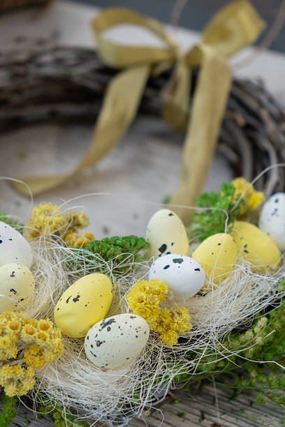 Handmade Easter wreath festive yellow egg decorations. Traditional holiday preparation craft master class of creative making decor. Hands-on activities sustainable responsible holiday gift workshop creation