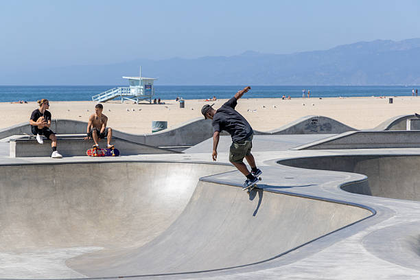 Los Angeles, California, United States - September 28 2022: Skaters riding and practicing tricks at the skate park in the Venice Beach area, showing active youth culture and urban lifestyle.