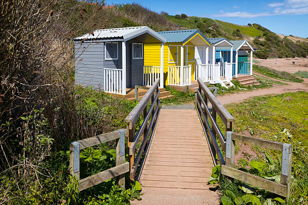 Holidays in Scotland – Colorful beach huts on a summer day on the cliff coast near St. Abbs, UK