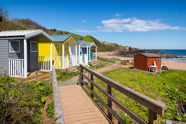 Holidays in Scotland – Colorful beach huts on a summer day on the cliff coast near St. Abbs, UK