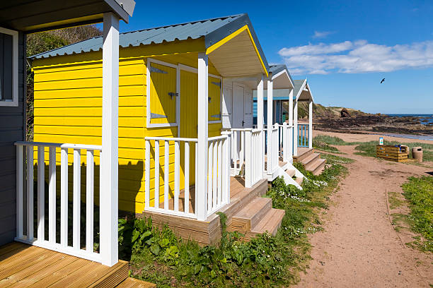 Holidays in Scotland – Colorful beach huts on a summer day on the cliff coast near St. Abbs, UK