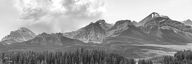 Scenic Banff National Park mountains during summer under blue sky and bright sunlight in black and white.