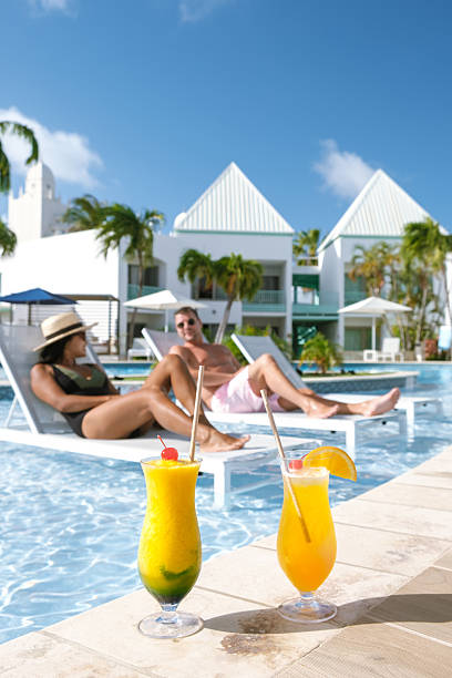Relaxing under the sun with tropical drinks by the pool in beautiful Aruba