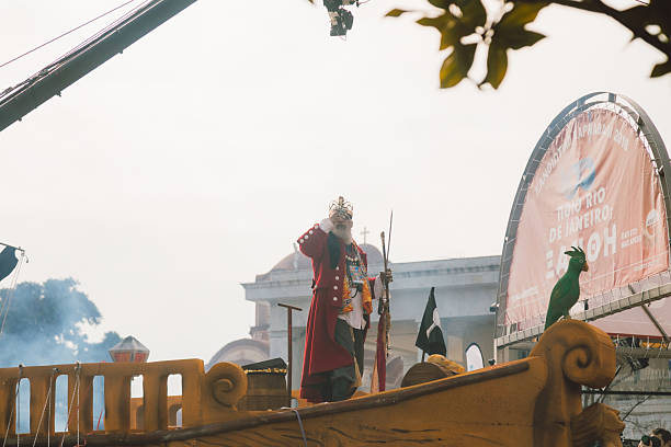 Xanthi, Greece - February 18, 2018: A costumed performer dressed as a historical character stands on a decorated parade float during the annual Xanthi Carnival as crowds gather to celebrate one of the largest and most vibrant carnival festivals in northern Greece