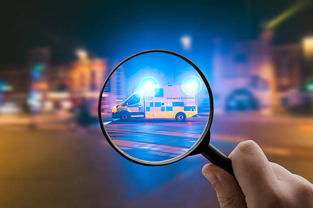 A magnifying glass focusing on emergency vehicle lights at night, symbolizing urgency and public safety.