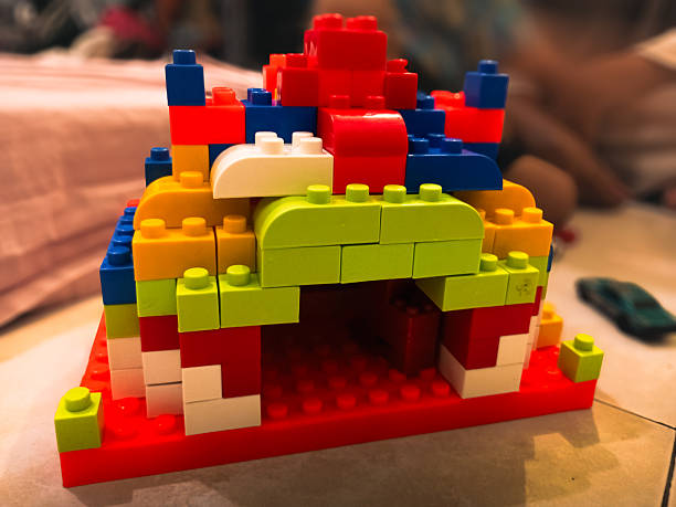 A colorful house structure built from plastic building blocks for children's creative play