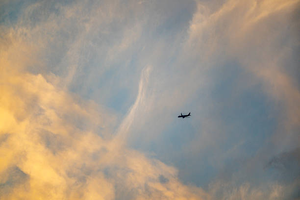 Beautiful silhouette of airplane on sunrise background.