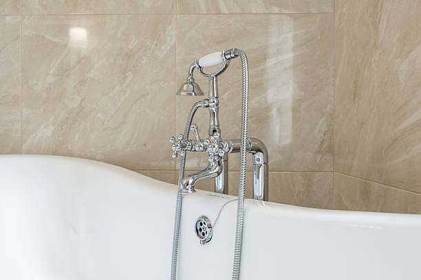 A bright bathroom with turquoise and white checkered tiles and a classic white bathtub, creating a vibrant atmosphere with its cheerful color scheme. The setting suggests simplicity and minimalism.