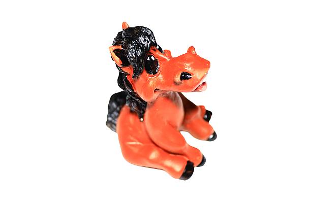 A small toy horse with a distinctive black mane on its back.