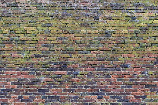Traditional red brick wall with bricks aged by weathering