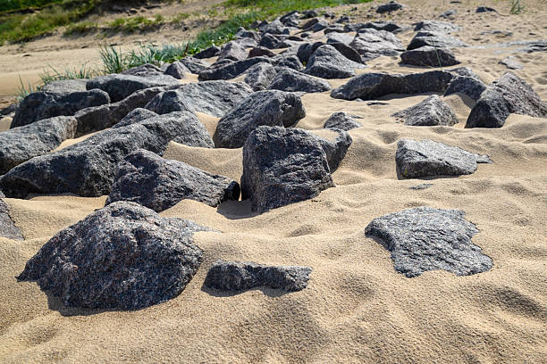 Baltic Sea pier stones on the sand.