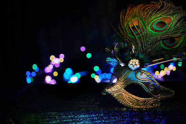 istock Masquerade mask with peacock feathers bringing mystery and celebration bokeh lights 2256900275