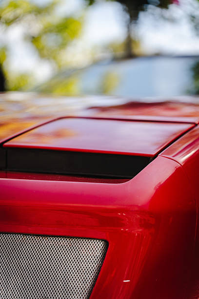 Close up of a retro car headlight showcasing polished metal accents, glass lens, and intricate craftsmanship for automotive and lifestyle visuals.
