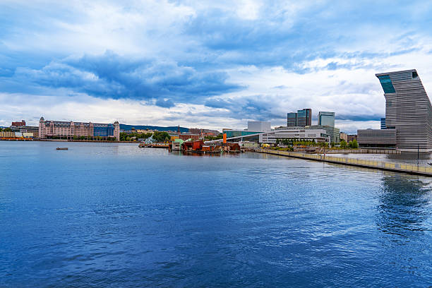 Oslo, Bjorvika waterfront skyline in summer sunny day showing modern architecture and calm harbor waters
