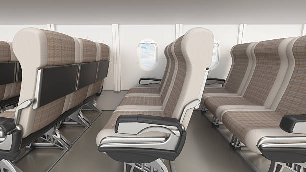 istock Empty airplane seats in a cabin with a window showing clouds and sky outside during a flight 2256906126