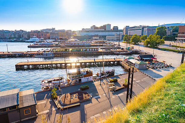 Oslo evening sun over Pipervika harbor in central Oslo Norway with boats, piers and city skyline