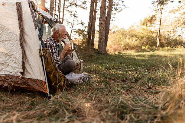 istock Senior man enjoying morning coffee while camping 2256911882