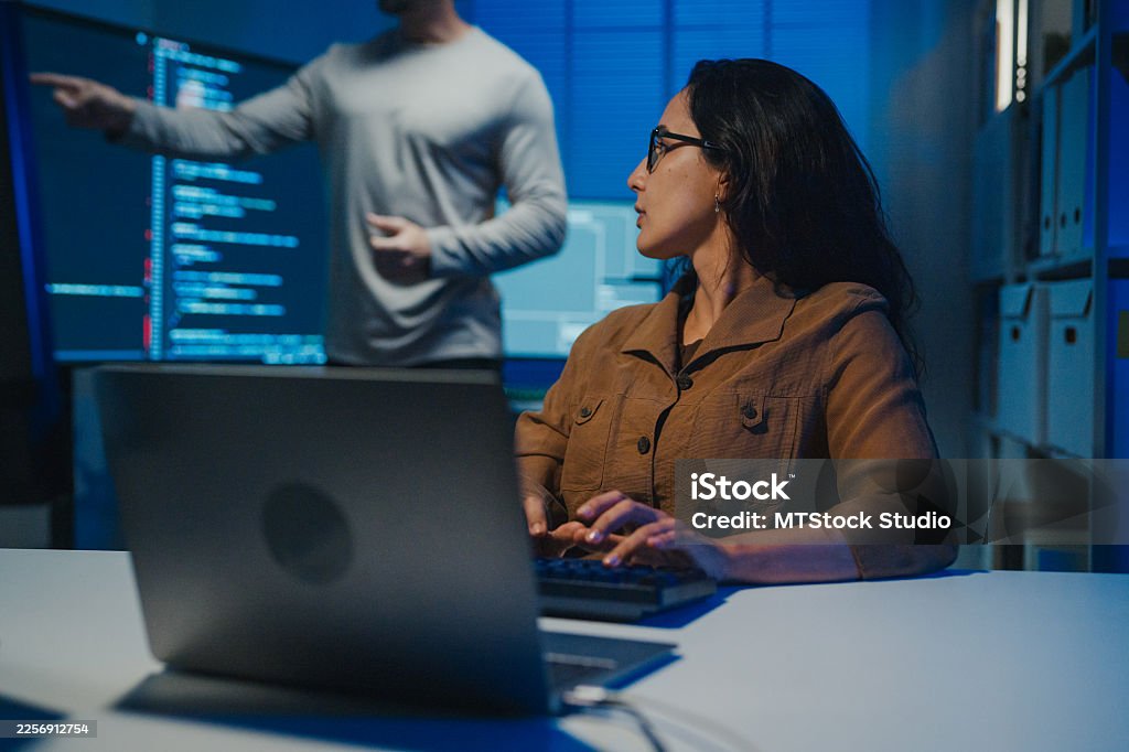 Young Latin software developers team meeting present source code on large monitors working late in the dark office at night. Artificial intelligence, implementation details, debugging and programming. Young Latin software developers team meeting present source code on large monitors working late in dark office at night. Artificial intelligence, implementation details, debugging and programming. Artificial Intelligence Stock Photo Young Latin software developers team meeting present source code on large monitors working late in the dark office at night. Artificial intelligence, implementation details, debugging and programming. Young Latin software developers team meeting present source code on large monitors working late in dark office at night. Artificial intelligence, implementation details, debugging and programming. Artificial Intelligence Stock Photo