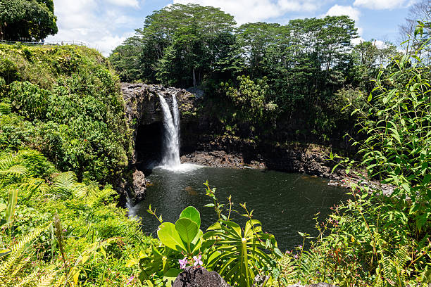 the mist often forms rainbows, precious waters over a lava cave