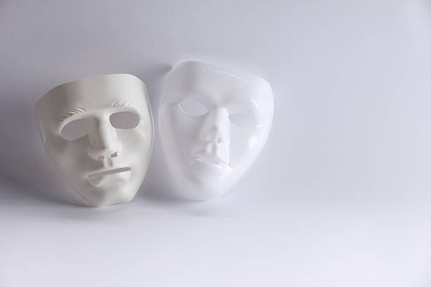 Black and white image of white paper mache mask in close up
