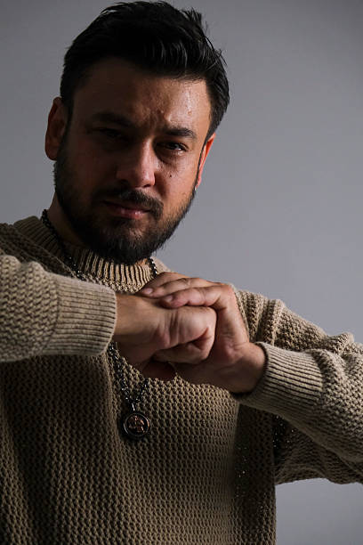 Confident brunette male in smart casual attire looking at the camera, perfect for lifestyle or business concept.