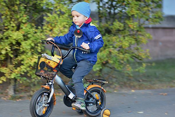 Photo of a father helping one of his sons fasten his seat belt before their cargo bike ride.