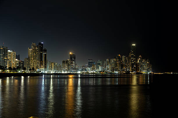 Panama city skyline lighting up the night reflecting on the tranquil bay water