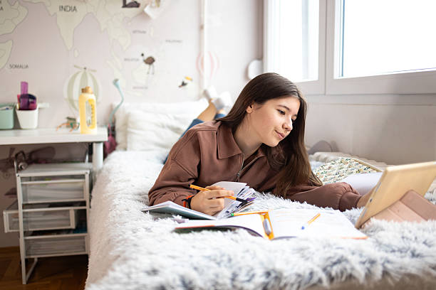 istock Teenage student studying on bed using digital tablet at home 2256925774