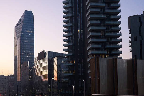 Milan, Italy - 2025, February 6 : Some modern buildings with the BNP Paribas headquarters illuminated by the rising sun in Milan, Italy