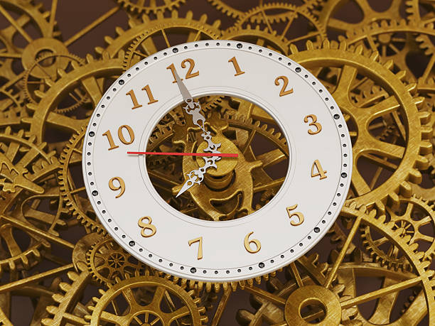A clock positioned in the center of a network of golden gears shows the time with distinct numbers and hands. The clock has a white frame and red second hand.