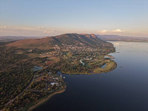 Captivating aerial shot showcasing the scenic beauty of Hartbeespoort, South Africa during a tranquil sunset.